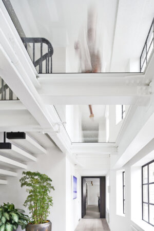 A bright, first-floor hallway with a walkable glass ceiling.